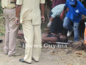 Undertakers prepare to remove the body of murdered businessman, Rajendra Singh. 