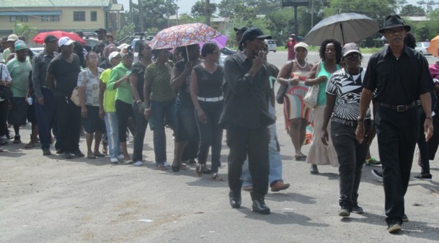 APNU protestors march in silence to mourn “the death of democracy” in Guyana