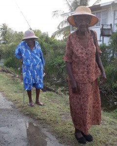 Two elderly women make their way to the polling station at Manchester Village, Corentyne. [iNews' Photo]