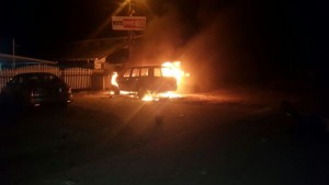 The Pastor's vehicle on fire in front his house.