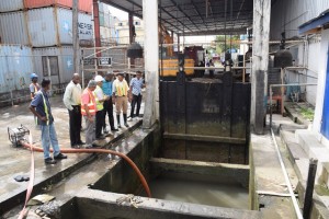 Minister of Public Infrastructure, David Patterson and Engineering Consultant, Walter Willis at the Church Street outfall located at Muneshwar’s wharf, where desilting is ongoing 