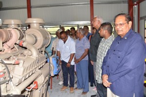 Prime Minister Moses Nagamootoo and Minister of Agriculture Noel Holder look on as the drainage pump at Joppa, Number 43 Corentyne Berbice Region Six is being switched on 