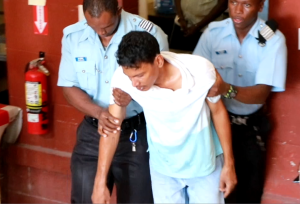 Ranks ushering Michael Persaud out the courthouse on Wednesday, moments before he reportedly ingested the poisonous substance while in Police custody 